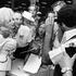 Dolly Parton pauses to pose for a photo as she signs autographs for fans in Nashville