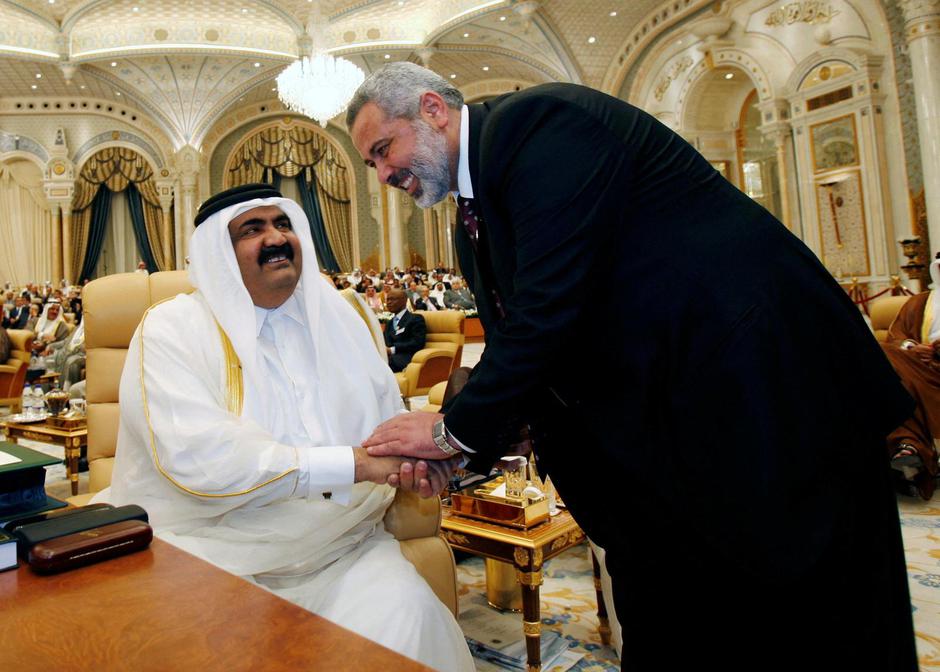 FILE PHOTO: Palestinian Prime Minister Ismail Haniyeh greets Qatar's Sheikh Hamad bin Khalifa al-Thani during the Arab summit in Riyadh | Author: AHMED JADALLAH/REUTERS