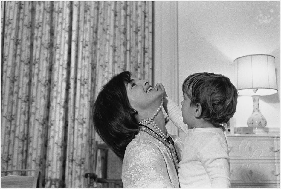 This photograph shows Mrs. Jacqueline Kennedy and her son, John F. Kennedy Jr., in the White House nursery. The image highlights the domestic life of the First Family during the Kennedy administration, reflecting the early years of John Jr.'s life in the  | Author: Profimedia