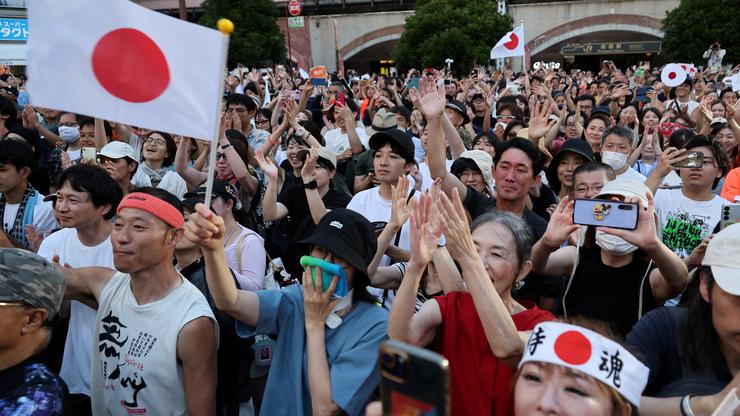 FILE PHOTO: Supporters of Japan's Sanseito party leader react during the party’s rally in Tokyo