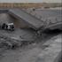 A damaged portion of a bridge in the aftermath of a strike, in Bandar Khamir