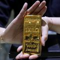 FILE PHOTO: A staff member shows a one kilogram gold bar at the Galeri 24 gold and jewellery shop in Jakarta