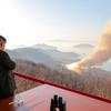North Korea's Kim Jong Un observes a ground ejection test of a high-output solid-fuel engine using carbon fiber composite materials