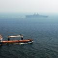 A merchant ship sails off the starboard side of amphibious assault ship USS Kearsarge (LHD 3) while transiting the Straits of Hormuz. Kearsarge is surge-deployed transporting elements of the 24th Marine Expeditionary Unit in support of Operation Iraqi Fre