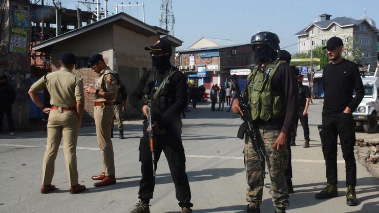 Indian police officers stand guard outside the police control room in Srinagar
