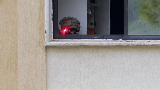 Israeli Soldiers Gather Behind Rubble In A Southern Lebanese Village