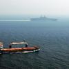 A merchant ship sails off the starboard side of amphibious assault ship USS Kearsarge (LHD 3) while transiting the Straits of Hormuz. Kearsarge is surge-deployed transporting elements of the 24th Marine Expeditionary Unit in support of Operation Iraqi Fre