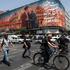People move past a billboard with an image depicting Iran's late Supreme Leader Ayatollah Ali Khamenei and late senior military commander General Qassem Soleimani, in Tehran