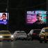 Cars drive past a screen advertising online retailer Wildberries in Moscow