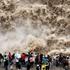 YAN AN, CHINA - SEPTEMBER 20: Tourists visit the Hukou Waterfall on the Yellow River as water volume significantly incre