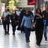 People walk on a street in Tehran