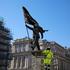 London, UK. 30 April 2026. Workers secure and fence off a newly unveiled Banksy sculpture in Waterloo Place, St James’s, central London, after the artist confirmed the work on Instagram. The statue depicts a suited man blinded by a large flag covering his