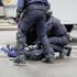 RENNES, FRANCE - 13 OCTOBER 2026: Riot police detain a man lying face down on the road beside a CRS water cannon truck during a street demonstration