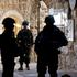Israeli soldiers stand guard during a weekly settlers' tour in Hebron