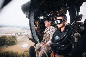 A Royal Thai Army Special Forces Soldier (right) and a U.S. Army Soldier, 1st Special Forces Group (Airborne) (left) prepare to jump from a UH-60 Blackhawk helicopter as part of helo-cast training during Hanuman Guardian 2022 in Lopburi, Kingdom of Thaila