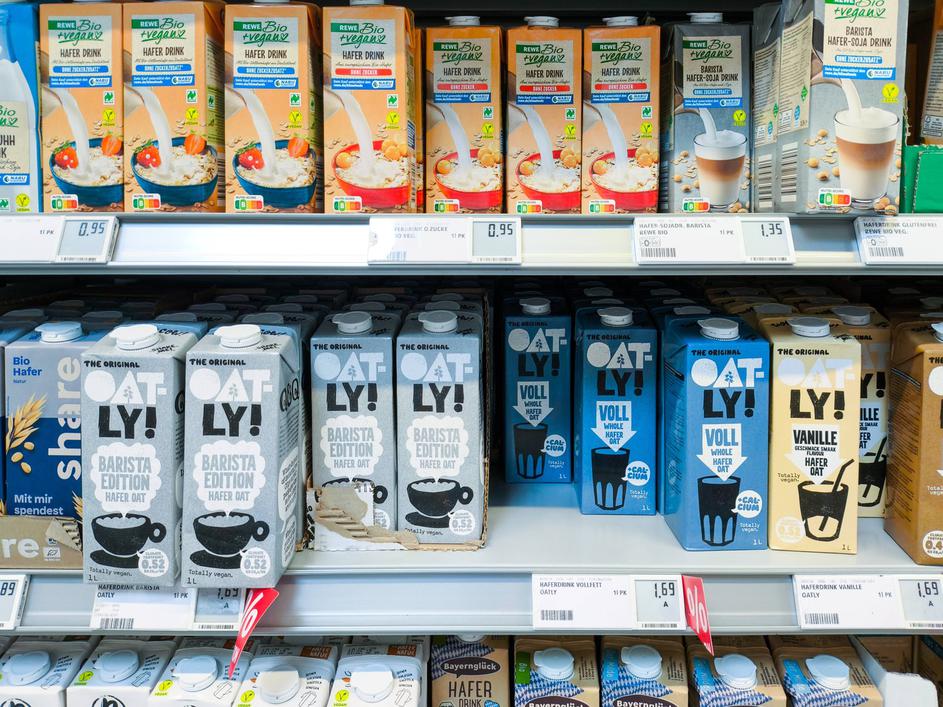 Bavaria, Germany - August 12, 2024: Selection of vegan milk alternatives, including oat drinks from brands such as Oatly
