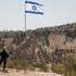 FILE PHOTO: Israeli flag flutters, as part of the Israeli settlement of Maale Adumim is visible in the background, in the Israeli-occupied West Bank