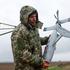 FILE PHOTO: Ukrainian serviceman carries an interceptor drone, part of MEROPS system, during a training at an undisclosed location in Ukraine