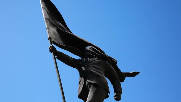 London, UK. 30 April 2026. A new artwork by Banksy appears in Waterloo Place, St James’s, central London, after the artist confirmed the piece on his Instagram account. The sculpture depicts a suited man blinded by a large flag covering his face while ste