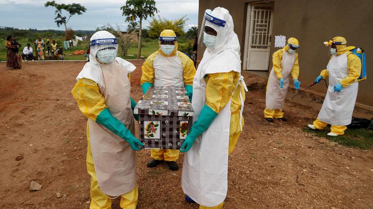 FILE PHOTO: Healthcare workers carry a coffin with a baby, suspected of dying from Ebola, in Beni