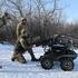 Ukrainian service members check and test a Browning М2 machine gun installed atop of a ground unmanned vehicle near a frontline in Zaporizhzhia region