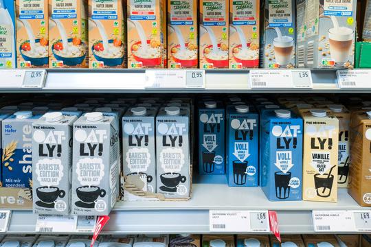 Bavaria, Germany - August 12, 2024: Selection of vegan milk alternatives, including oat drinks from brands such as Oatly
