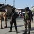 Indian police officers stand guard outside the police control room in Srinagar