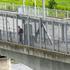 A man walks on bridge over Narva river in Narva