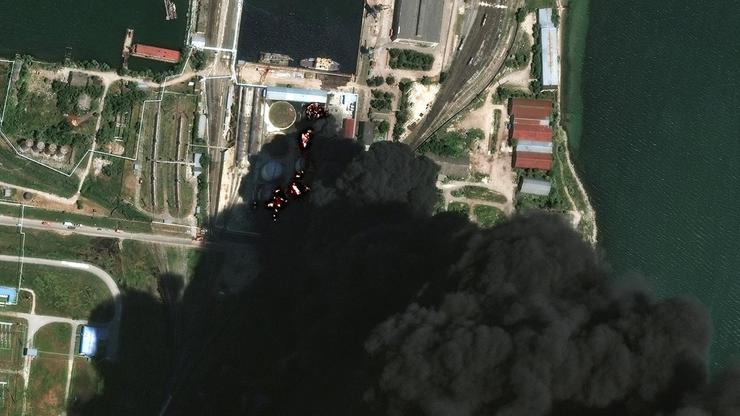 A satellite image shows fire and smoke rising from oil tanks, after what Ukrainian President Volodymyr Zelenskiy said was an attack on an oil depot in the city of Kerch