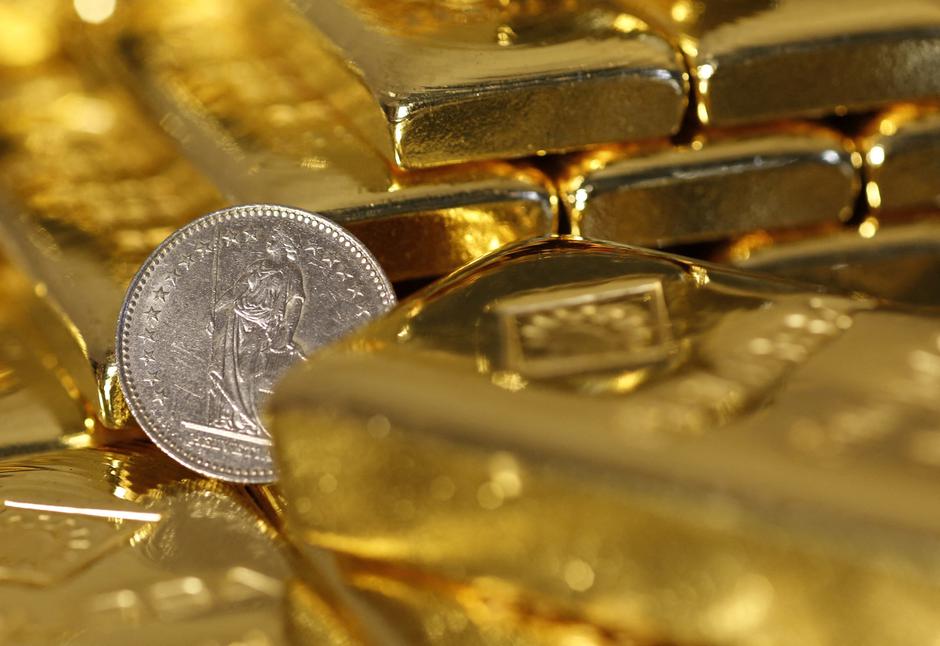 FILE PHOTO: Gold bars and a Swiss Franc coin are seen in this illustration picture in Vienna | Author: Leonhard Foeger