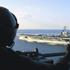 An aircrewman from Anti-Submarine Helicopter Squadron SEVEN (HS-7) looks on as USS HARRY S. TRUMAN (CVN 75) transits through the Straights of Hormuz. Truman is enroute to the Persian Gulf in support of Operation SOUTHERN WATCH. Subject Operation/Series: S