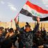 FILE PHOTO: A member of Iraqi Federal Police waves an Iraqi flag as they celebrate victory of military operations against the Islamic State militants in West Mosul