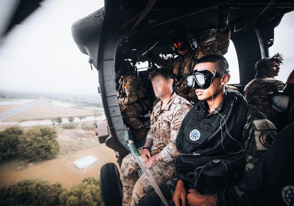 A Royal Thai Army Special Forces Soldier (right) and a U.S. Army Soldier, 1st Special Forces Group (Airborne) (left) prepare to jump from a UH-60 Blackhawk helicopter as part of helo-cast training during Hanuman Guardian 2022 in Lopburi, Kingdom of Thaila