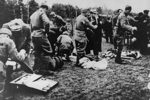 Ustase guards stealing the possessions of newly arrived prisoners in the Jasenovac concentration camp. Jasenovac was a camp system  in Croatia that included forced labour camps as well as the specific killing site at Donja Gradina). An estimated 500,000 p