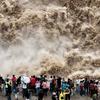 YAN AN, CHINA - SEPTEMBER 20: Tourists visit the Hukou Waterfall on the Yellow River as water volume significantly incre