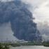 Thick plumes of smoke with flames rise from an oil refinery following a Ukrainian drone attack in Moscow