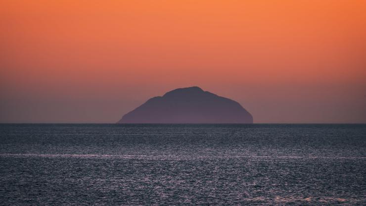 UK: WEATHER Troon , Ayrshire, Scotland 01st March 2022, the warm sun sets over ailsa craig and the goat fell tonight as we get closer to welcoming spring
