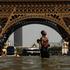 People cool off in the Trocadero Fountain near to the Eiffel Tower in Paris