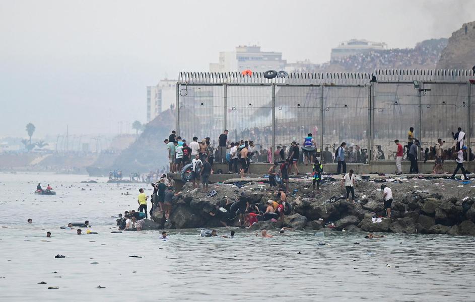 Migrants cross the border swimming through the sea, in Ceuta