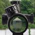 sniper look through the optical sight at a military base