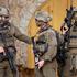 Israeli soldiers stand guard during a weekly settlers' tour in Hebron