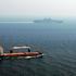 A merchant ship sails off the starboard side of amphibious assault ship USS Kearsarge (LHD 3) while transiting the Straits of Hormuz. Kearsarge is surge-deployed transporting elements of the 24th Marine Expeditionary Unit in support of Operation Iraqi Fre