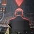 A woman walks past a billboard depicting Israeli Prime Minister Benjamin Netanyahu in the empty hall of the United Nations, on a building in Tehran