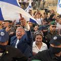 JERUSALEM - MAY 14: Israeli policemen escort Minister of National Security and far-right politician Itamar Ben-Gvir as he is surrounded with ultra-nationalist Israelis outside Damascus Gate during the Jewish nationalist "Flag March" to mark "Jerusalem Day