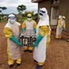 FILE PHOTO: Healthcare workers carry a coffin with a baby, suspected of dying from Ebola, in Beni
