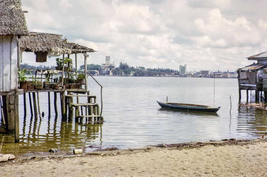 View across Straits from coastal village Kampong Lorong Fatimah in Singapore to Johor Bahru, Malaysia, Southeast Asia c 1964 | Author: Profimedia