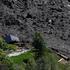 Debris and dust from a crumbling glacier that partially collapsed and tumbled onto the village of Blatten