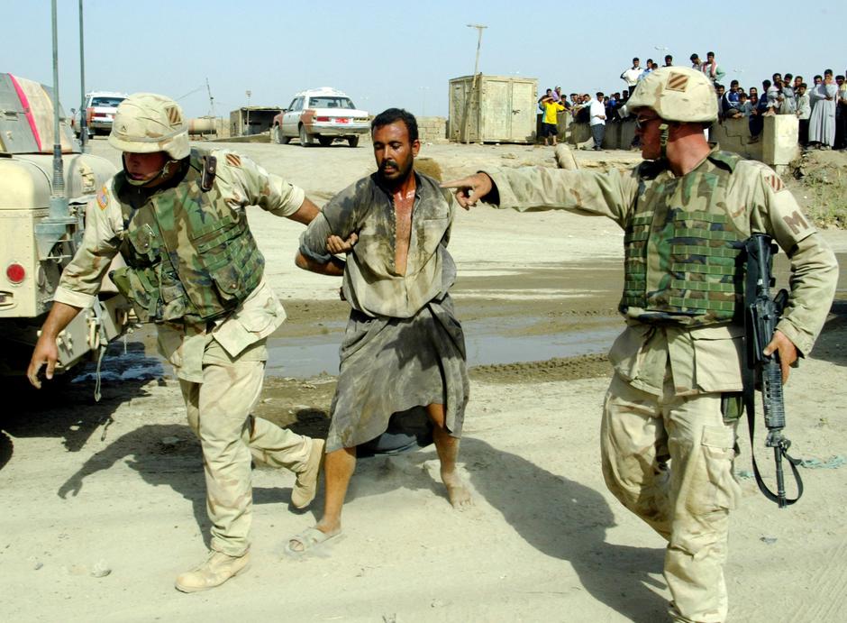 FILE PHOTO: Two US Military Policemen Arrest Iraqi Man In Al Fallujah | Author: Radu Sigheti