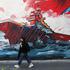 An Iranian woman walks next to an anti-U.S mural on a street in Tehran