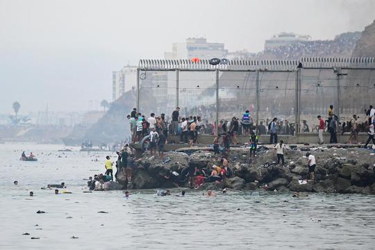 Migrants cross the border swimming through the sea, in Ceuta